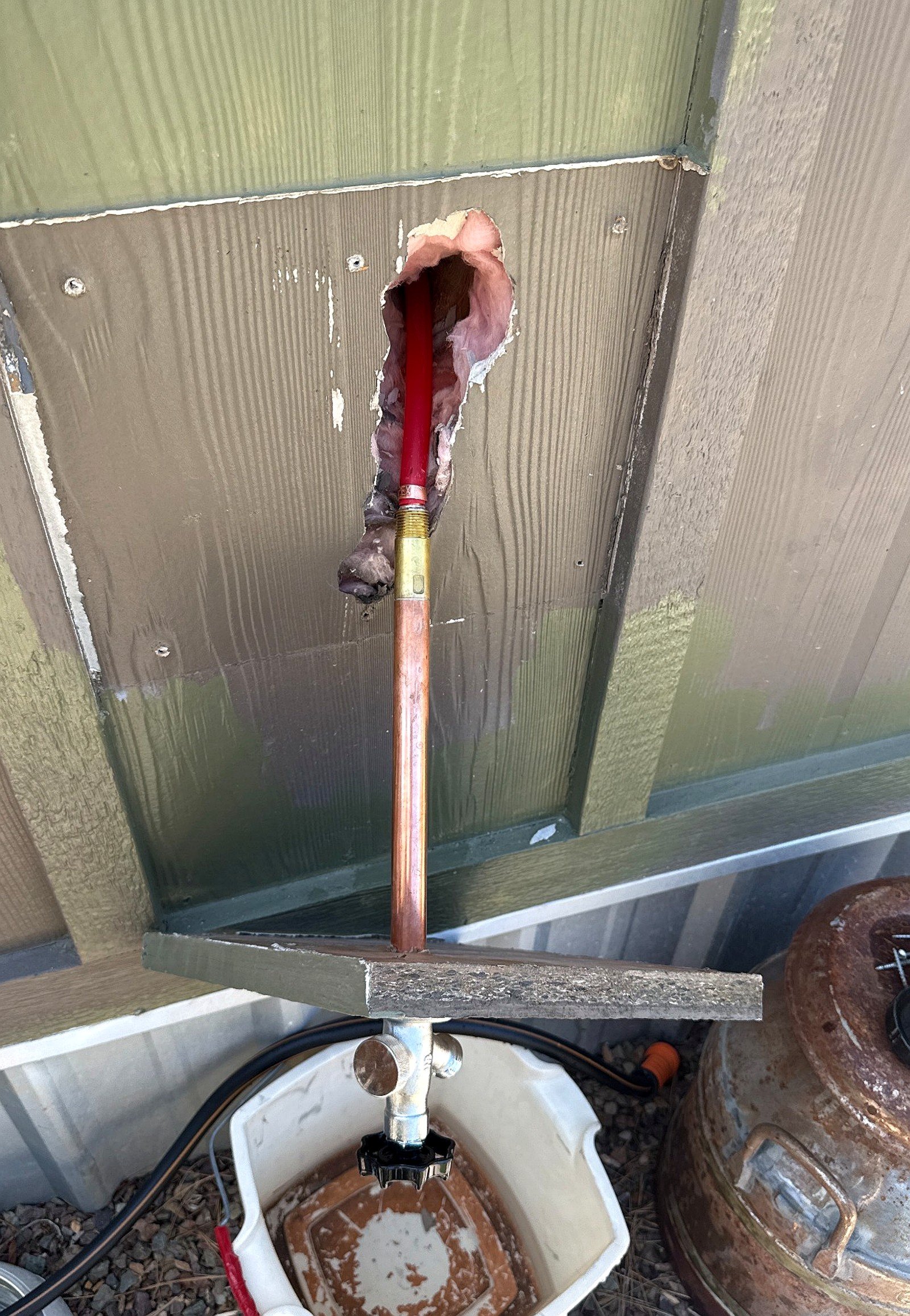 Outdoor hose bib and hose connection installed by Bear Hug Plumbing